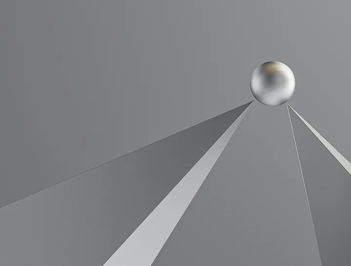 Greyscale image of two pointed spires balancing a ball.