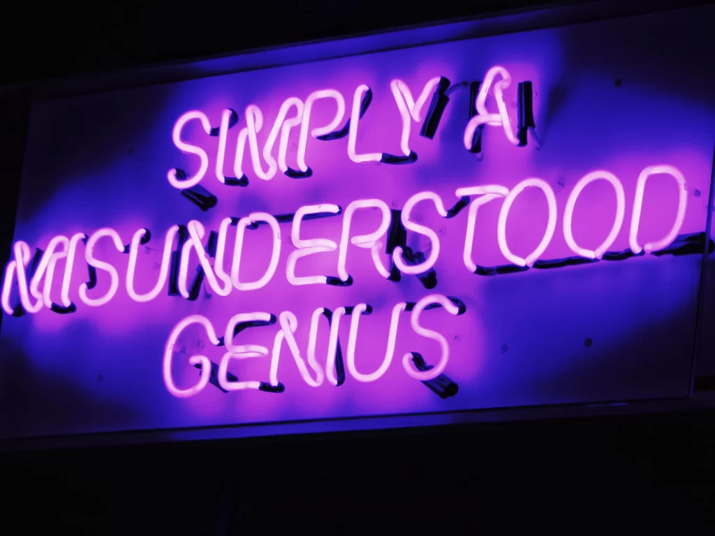 Neon sign reading: Simply a Misunderstood Genius