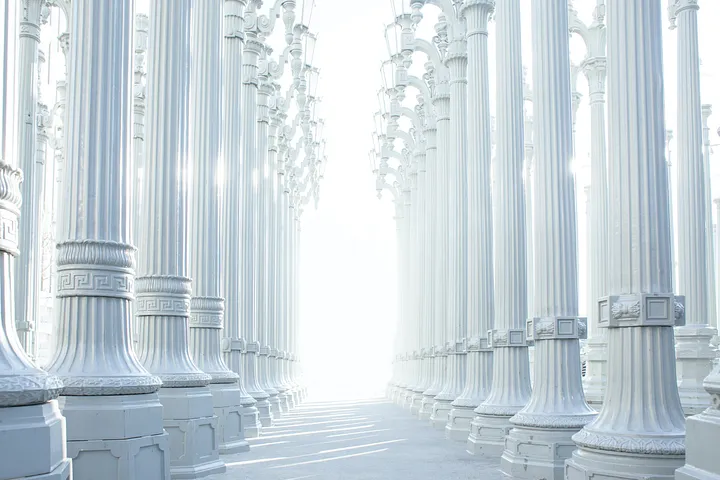 A hallway of silver white pillars