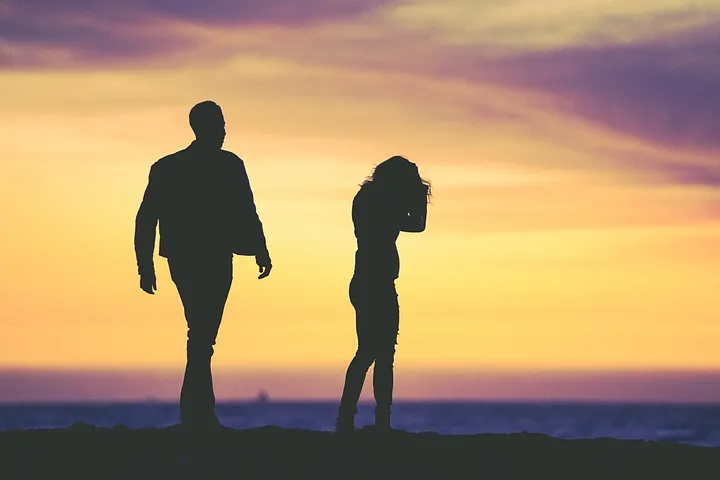 Man and woman in silhouette against sunset
