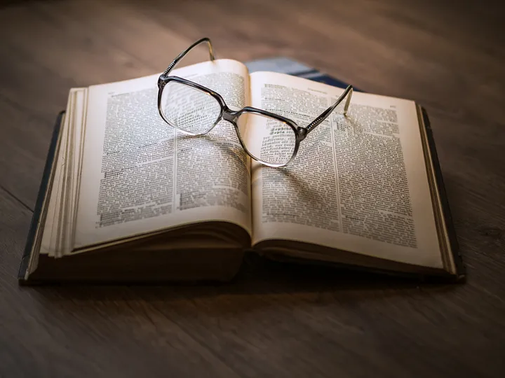 Eyeglasses on an open book