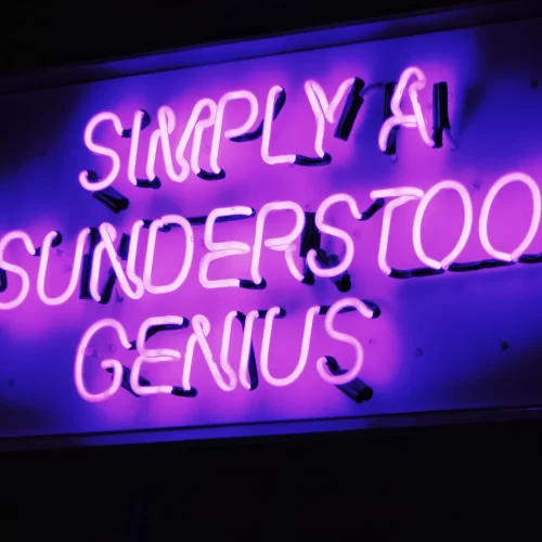 Neon sign reading: Simply a Misunderstood Genius