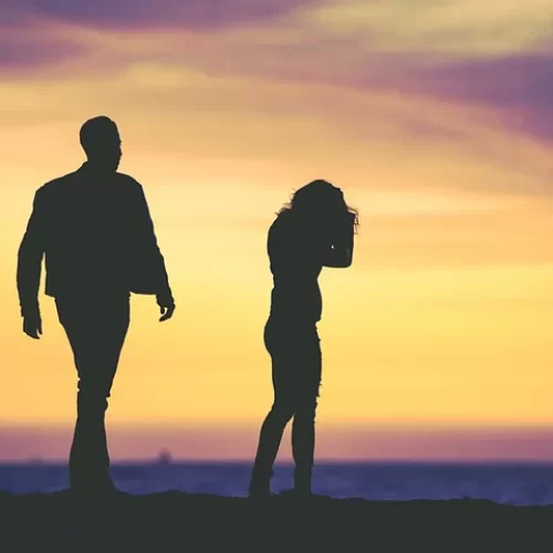 Man and woman in silhouette against sunset