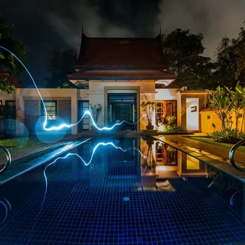 Blue lightning shooting across a pool into a house