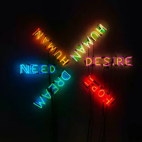 Neon sign with words human, desire, need, dream, and hope