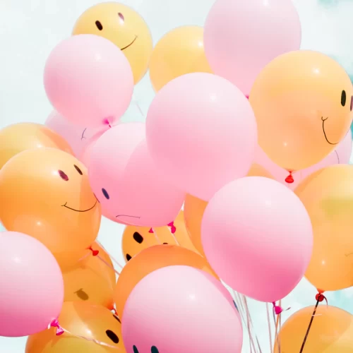 Pink and orange balloons with smiley faces
